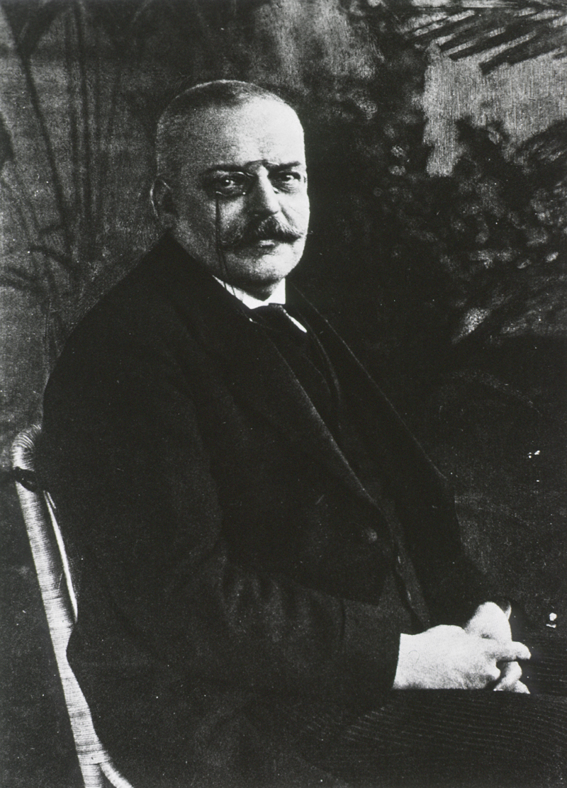 Black and white image of Dr. Alzheimer sitting in chair